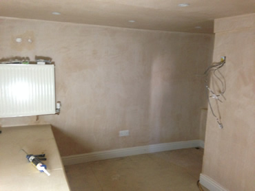 Walsall basement conversion with skirting, radiator, shelf and electrical switches being installed